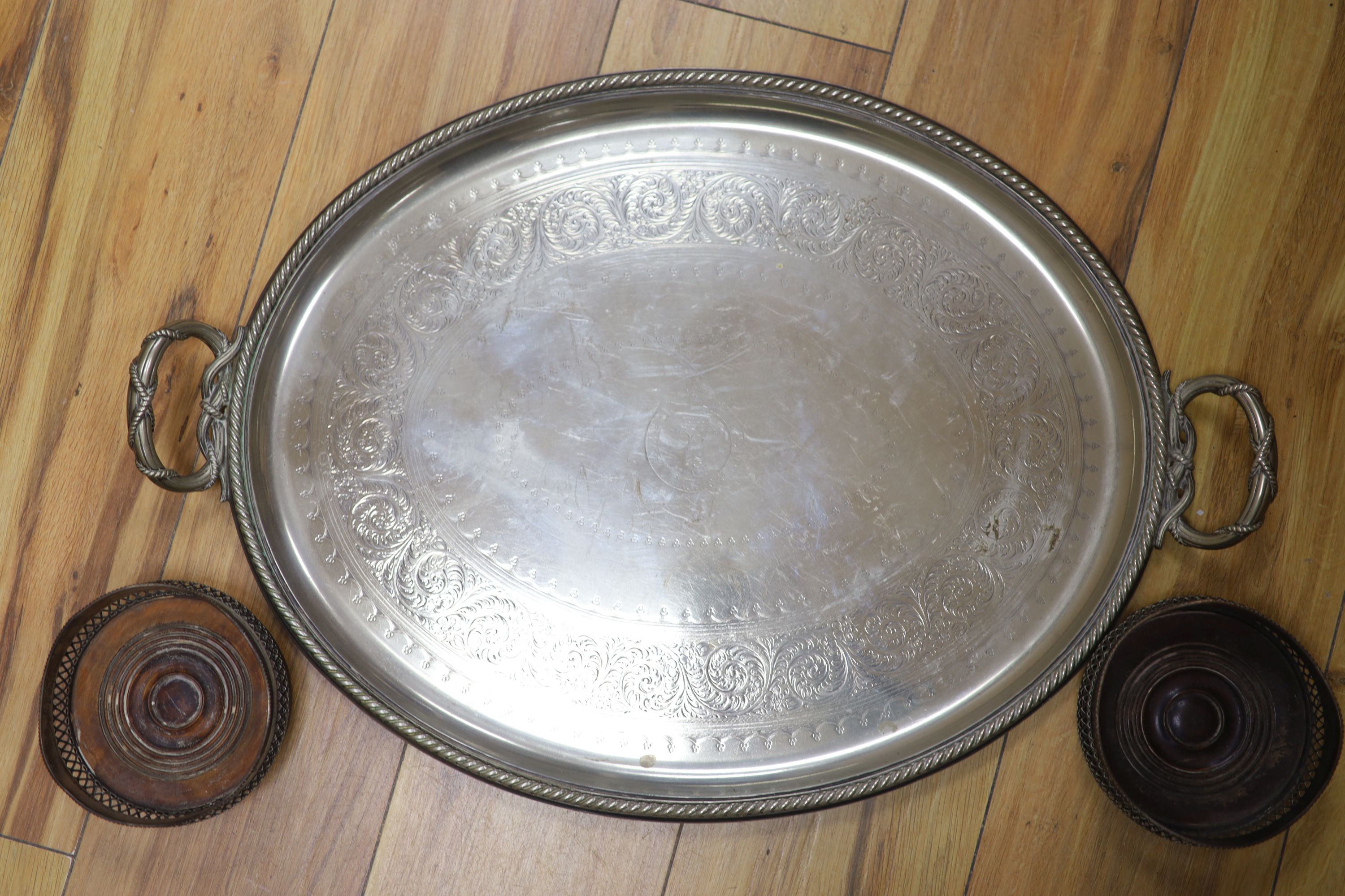 A pair of plated coasters, an oval salver and a tray